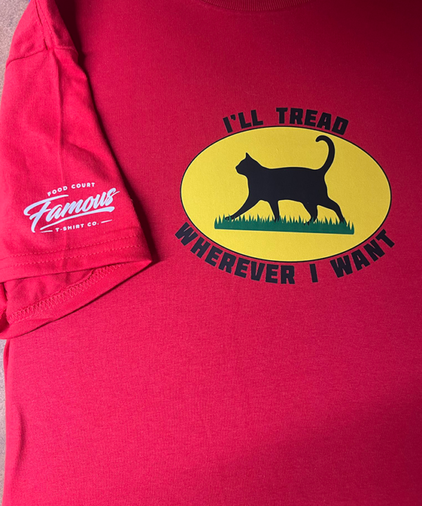 Woman wearing red I'll Tread Wherever I Want cat T-shirt with black cat graphic, funny Gadsden flag parody design